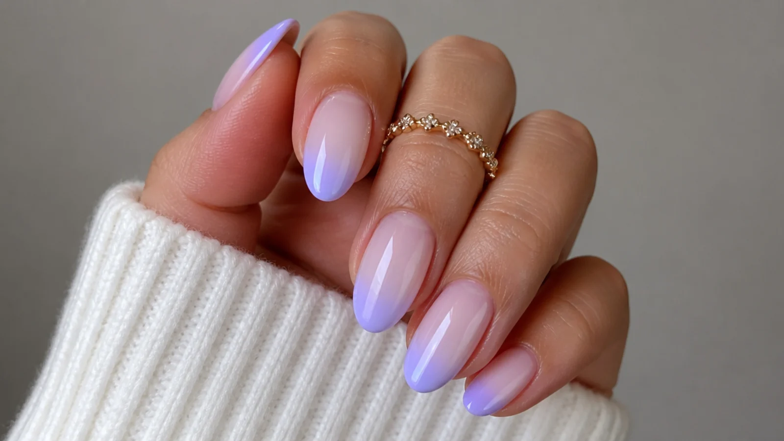Milky lavender to white ombre nails fading from tip to cuticle