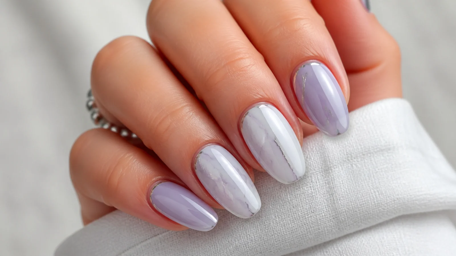 Milky lavender and white marble nails with soft gray veining