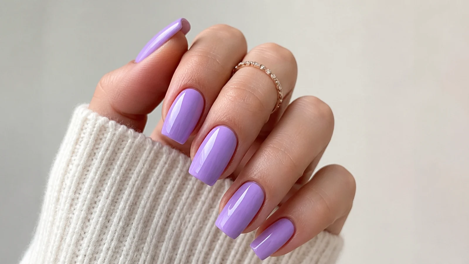 Cool-toned true lavender nails on fair skin, square shape