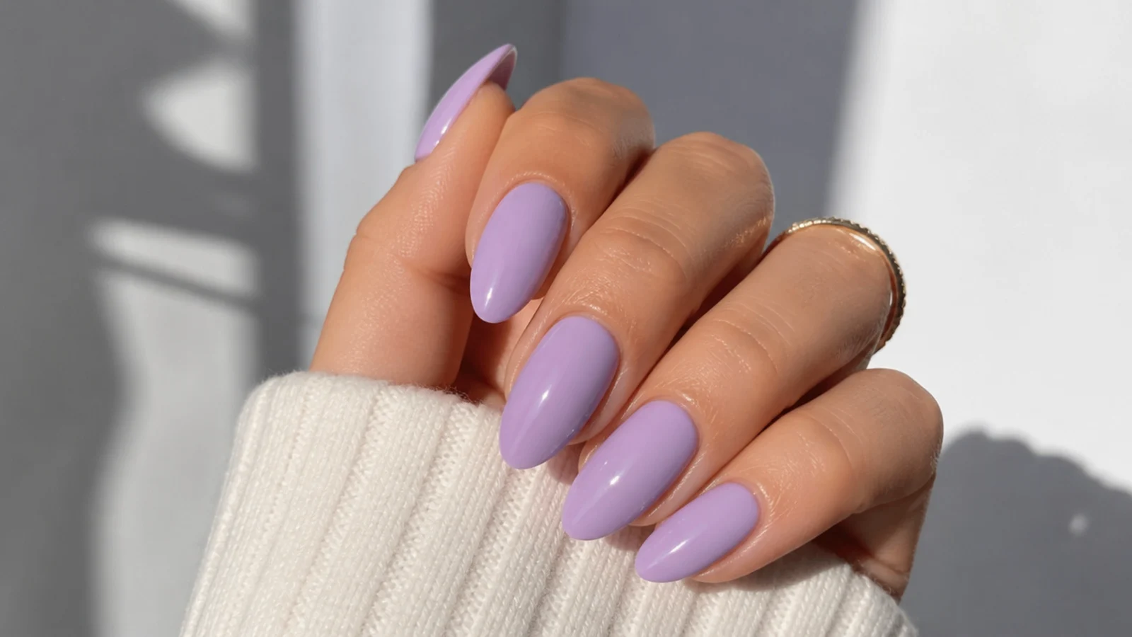 Glossy solid lavender nails on a medium almond shape