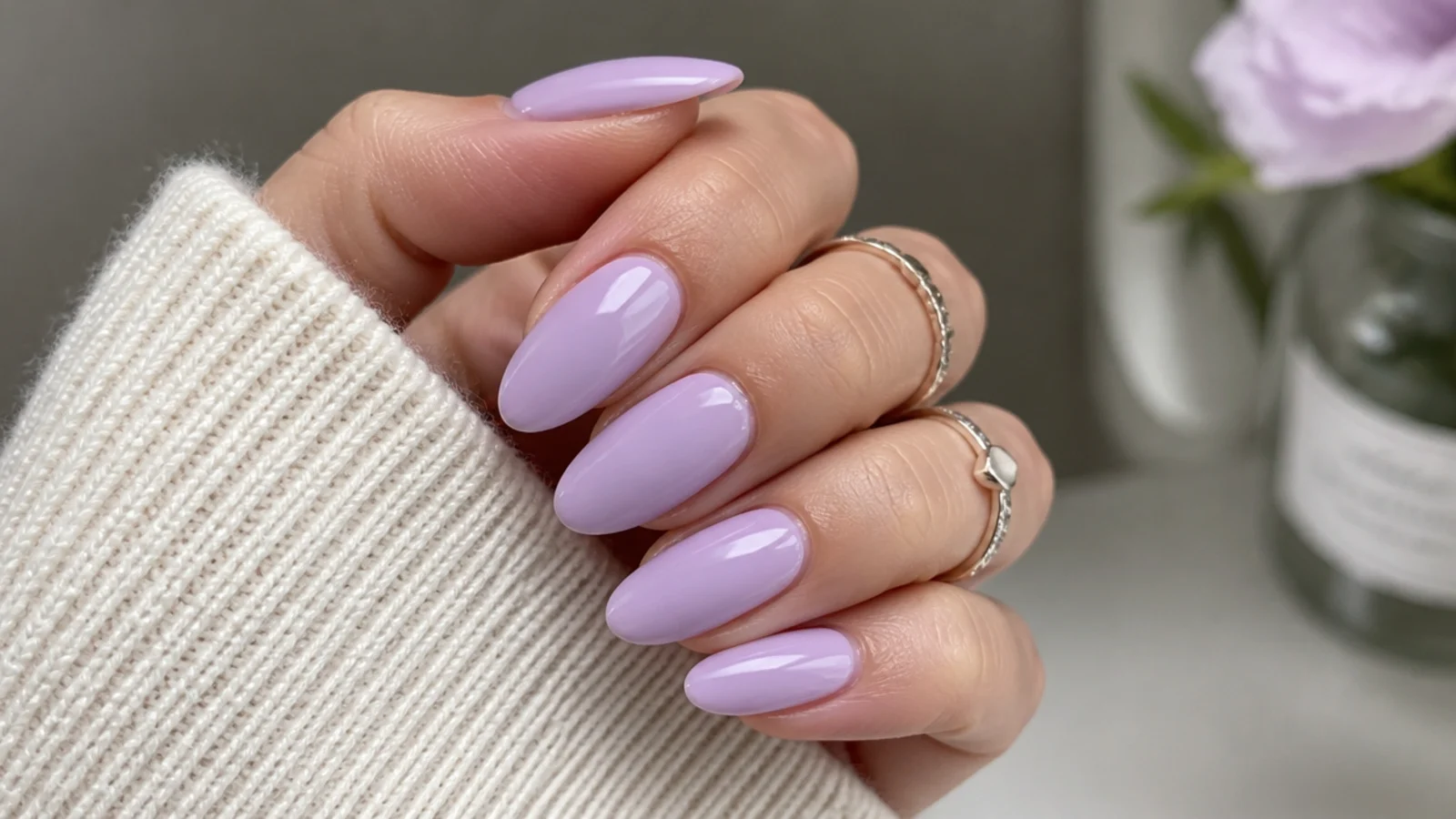 Soft pastel lavender nails in a milky lilac on an almond shape
