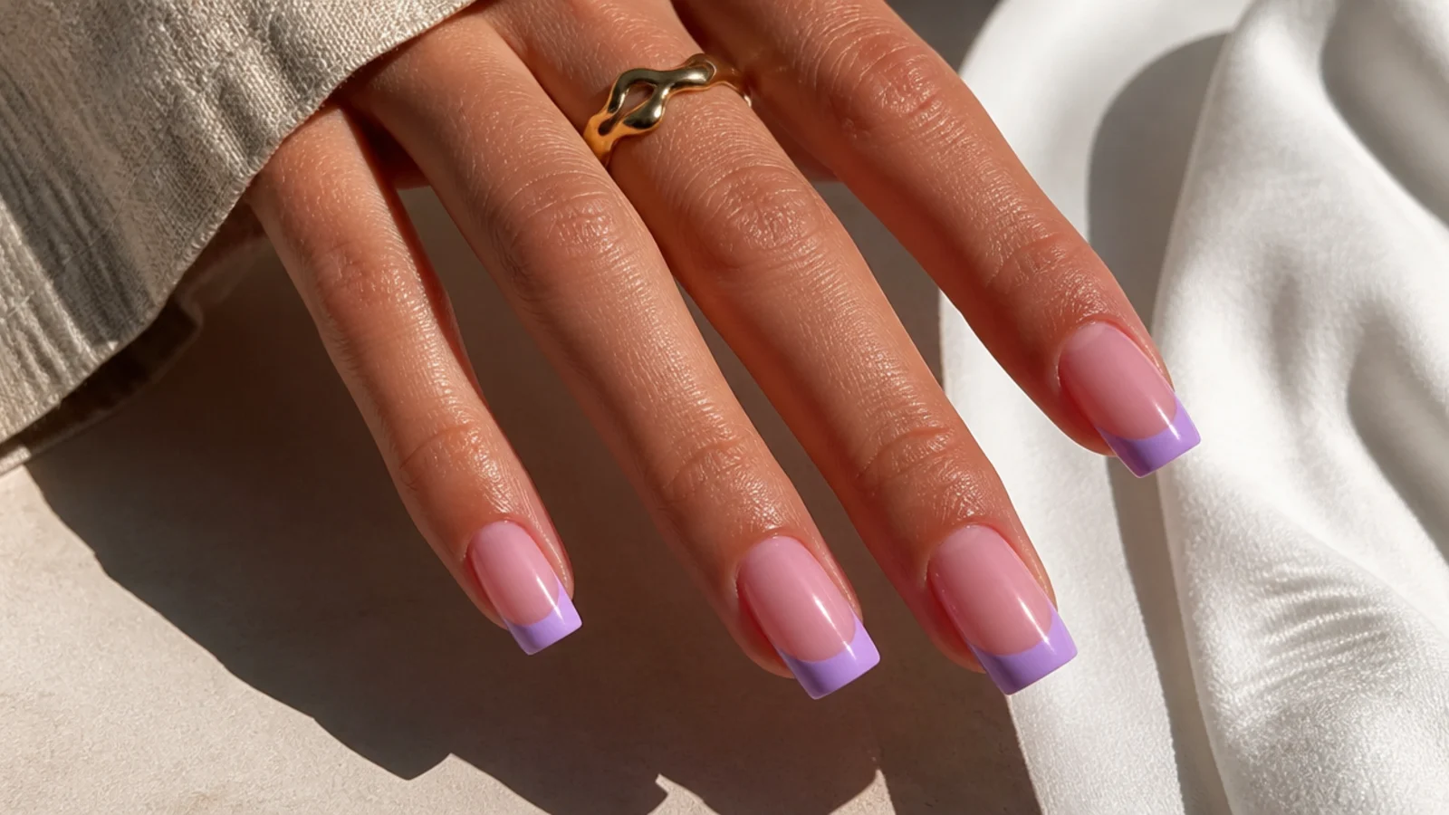Cool lavender French tips over a sheer pink base on square nails