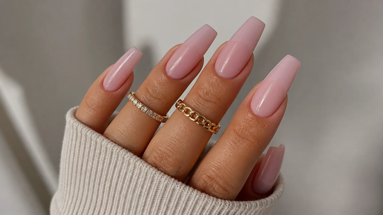 Warm pink-lavender milky glaze nails on tan skin, coffin shape