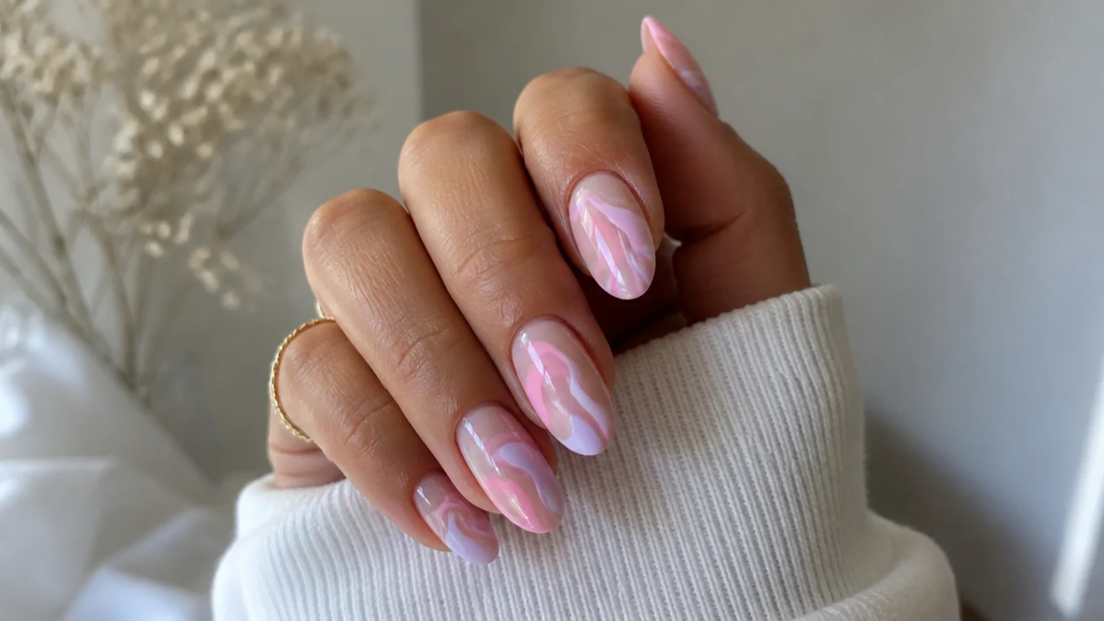 Pink and lavender swirl nails with wavy pastel lines on a milky base