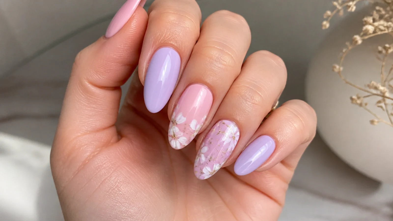 Soft pink and lavender nails on an almond shape with a milky lilac finish