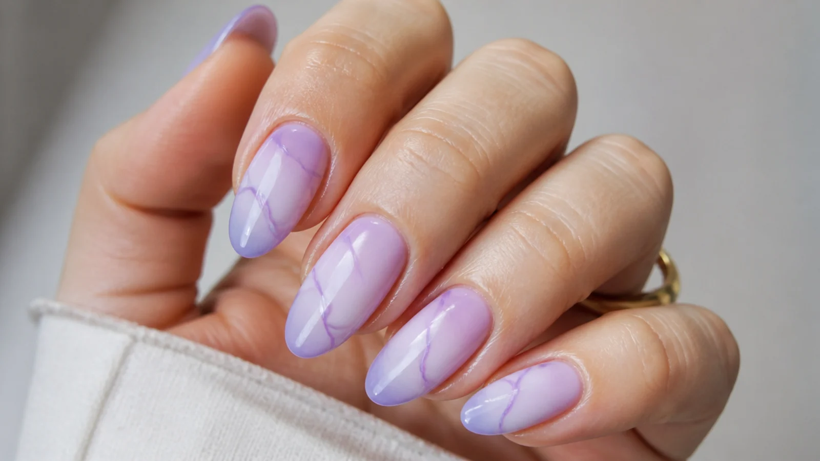 A well-sealed light purple gel manicure with cuticle oil for longevity