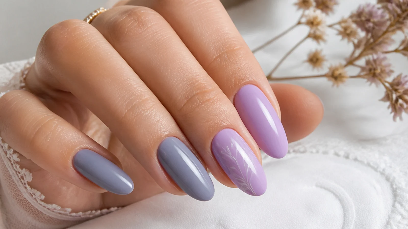 Soft gray-blue lavender nail beside a broader lilac light purple nail