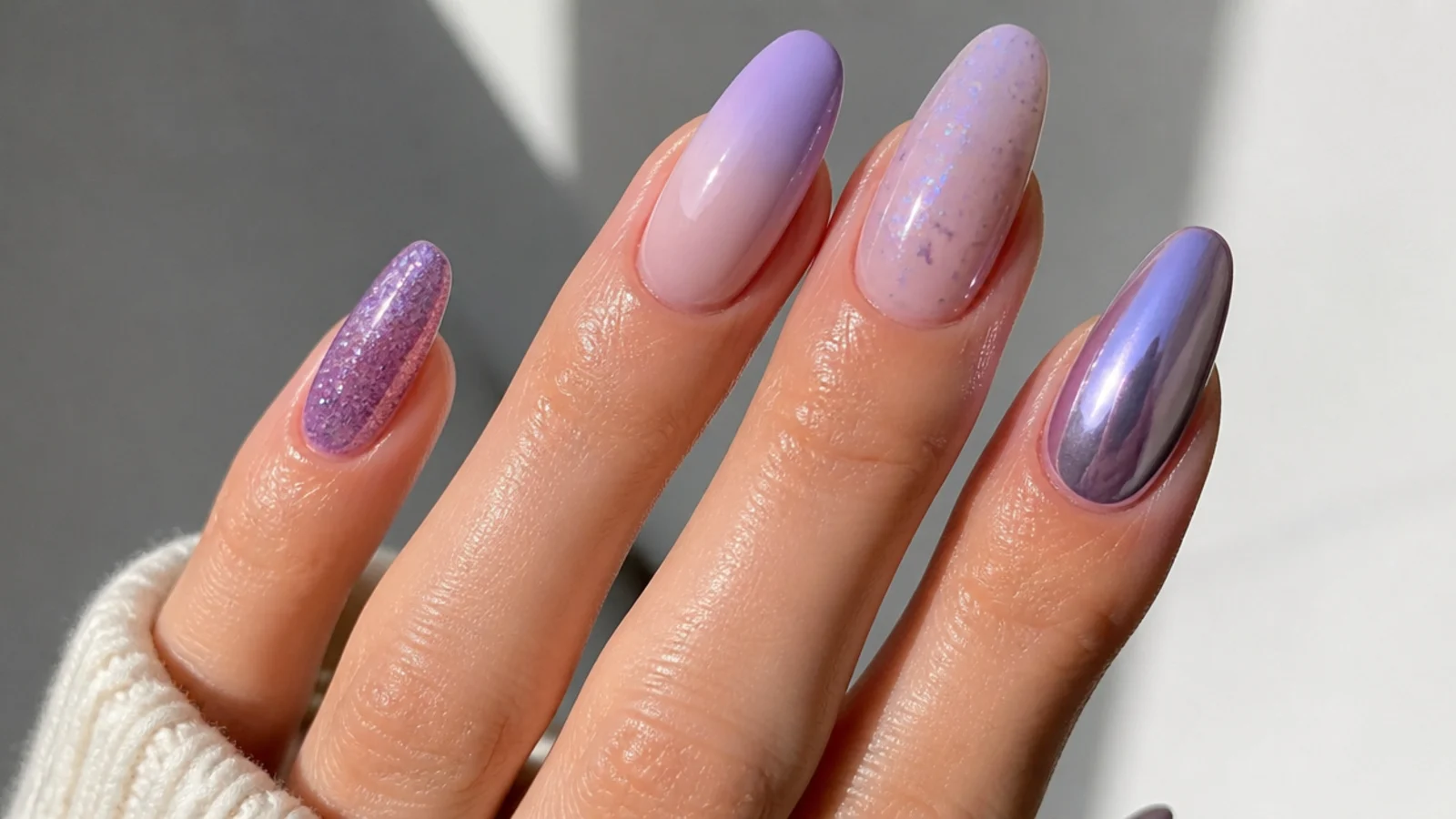 Light purple nails shown in chrome, milky, glitter and ombre finishes on almond shapes
