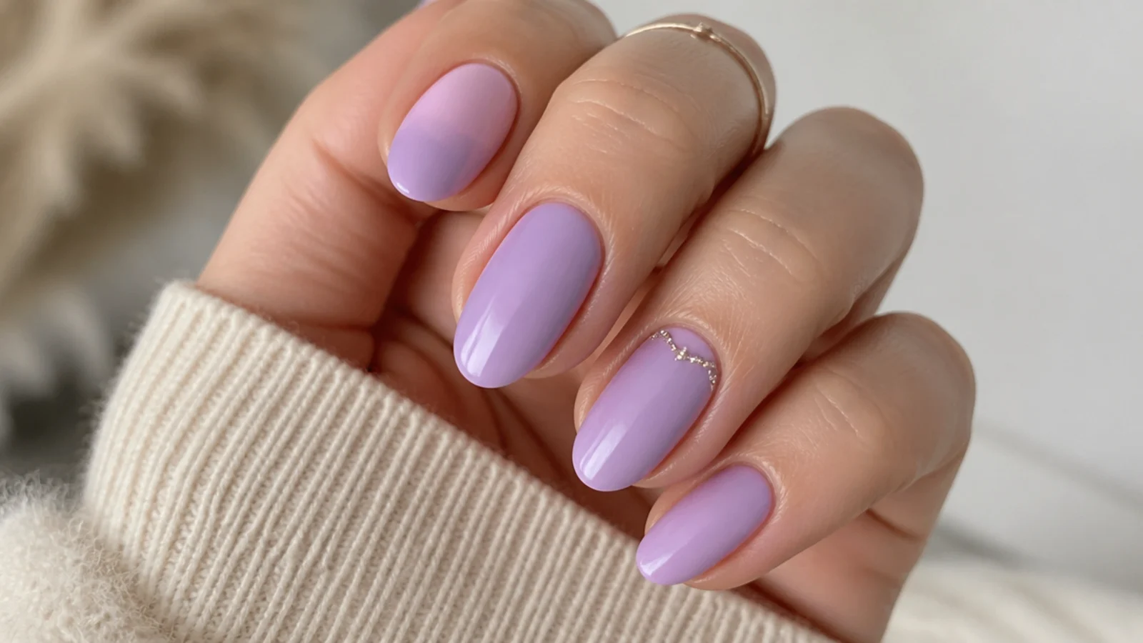 Soft light purple gel nails in a milky lilac shade on short almond nails at home