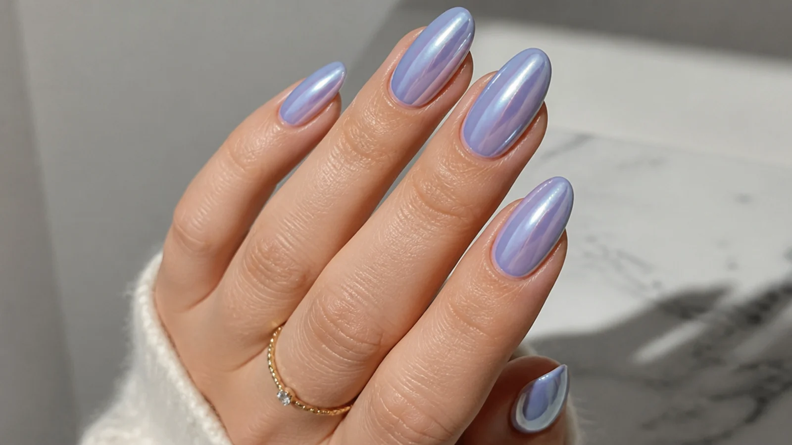 Periwinkle chrome nails shifting between blue and lilac