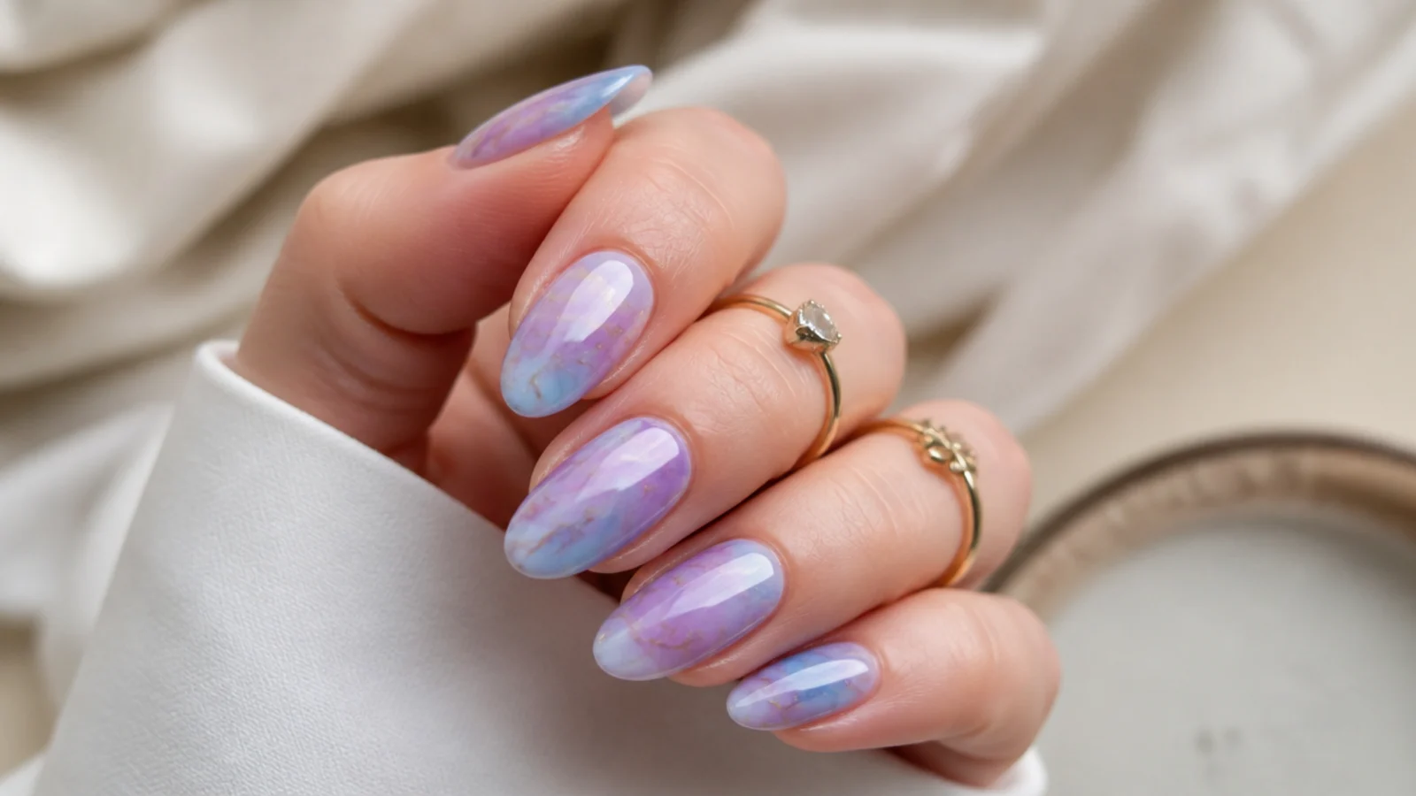 Soft blue and purple watercolor marble nails with hazy veining