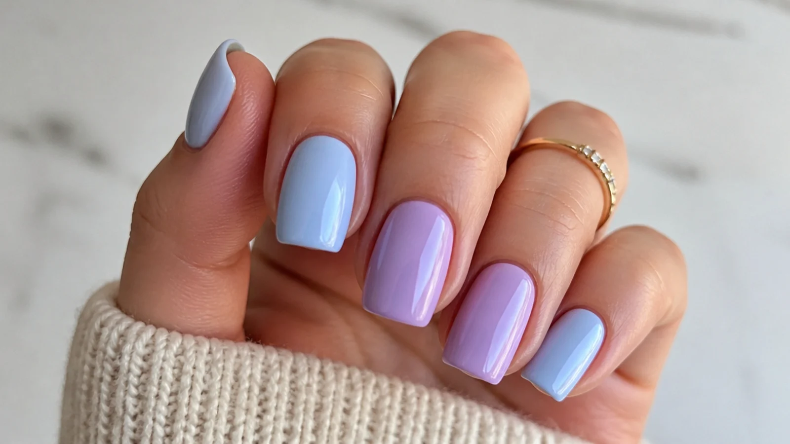 Alternating solid light blue and lilac nails across one hand