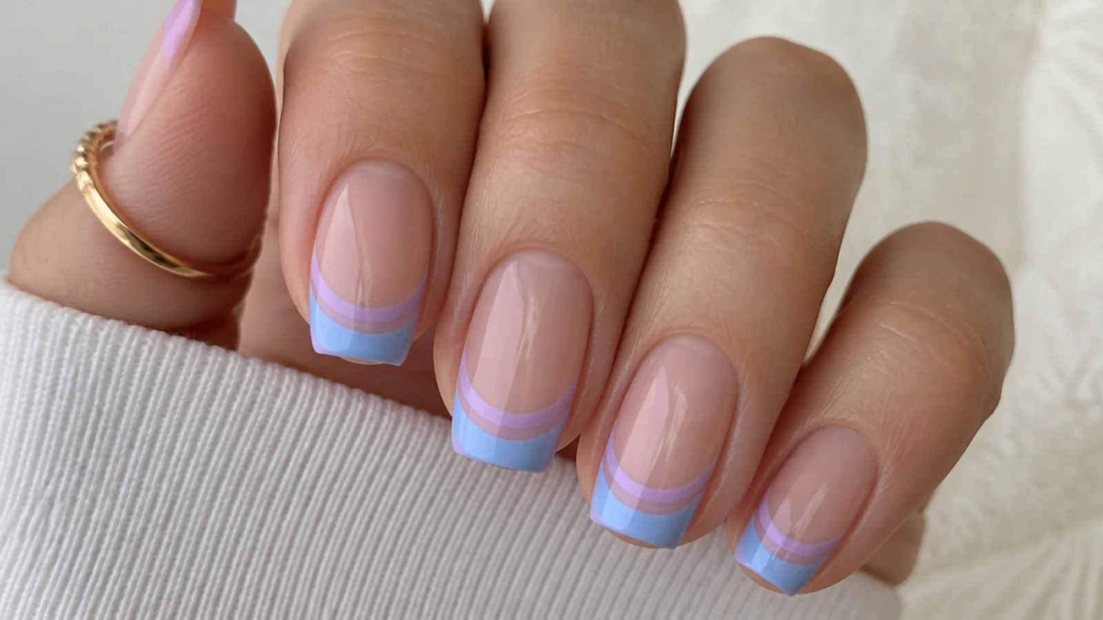 Double French tip nails in baby blue and lilac on a nude base