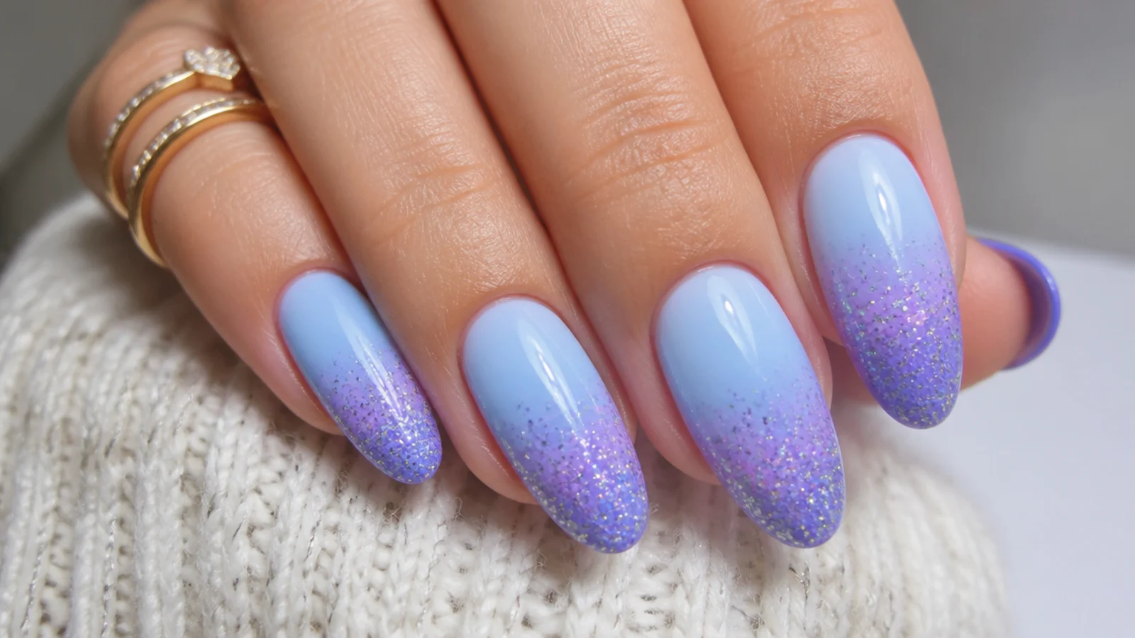 Light blue to purple nails with a glitter gradient at the tips