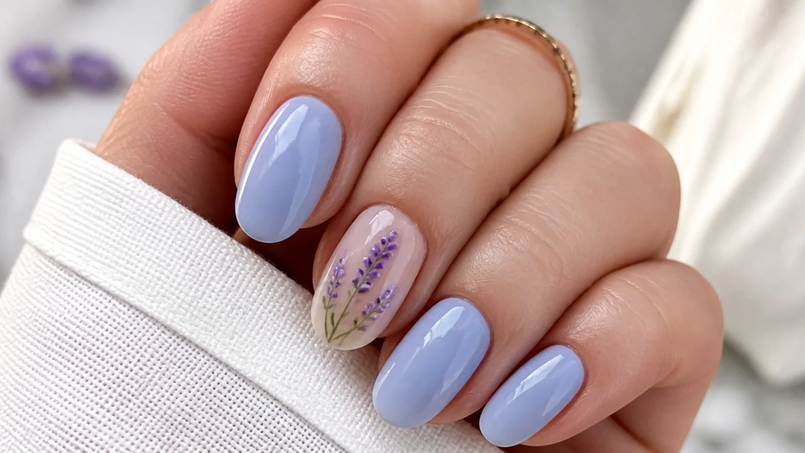 Light blue nails with a hand-painted lavender floral accent nail