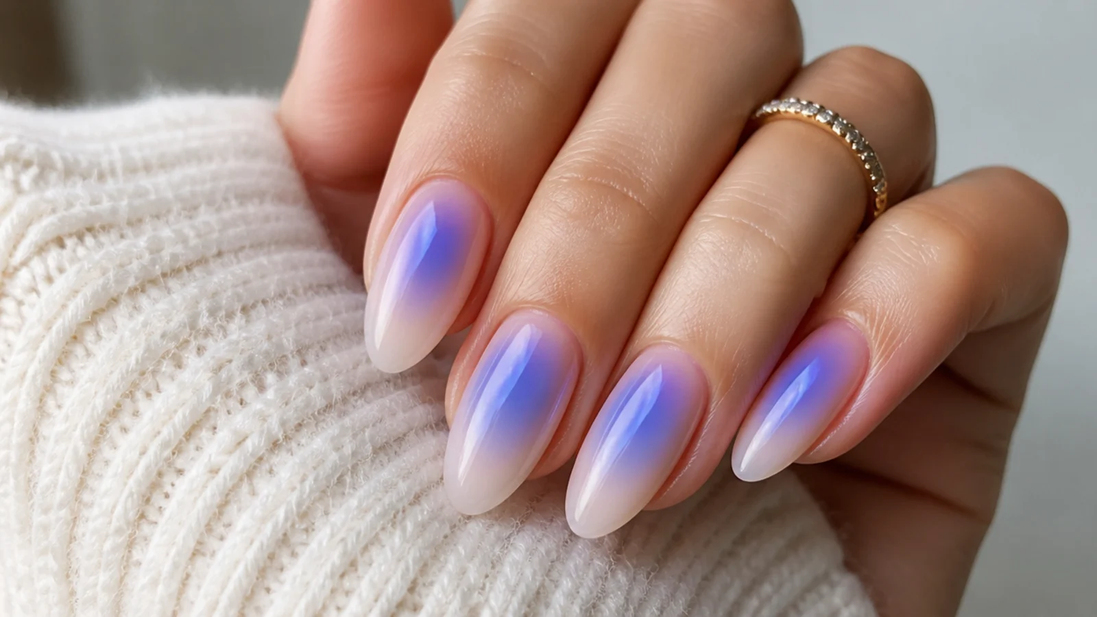 Aura nails with a soft blue-to-purple glow blurred at the center