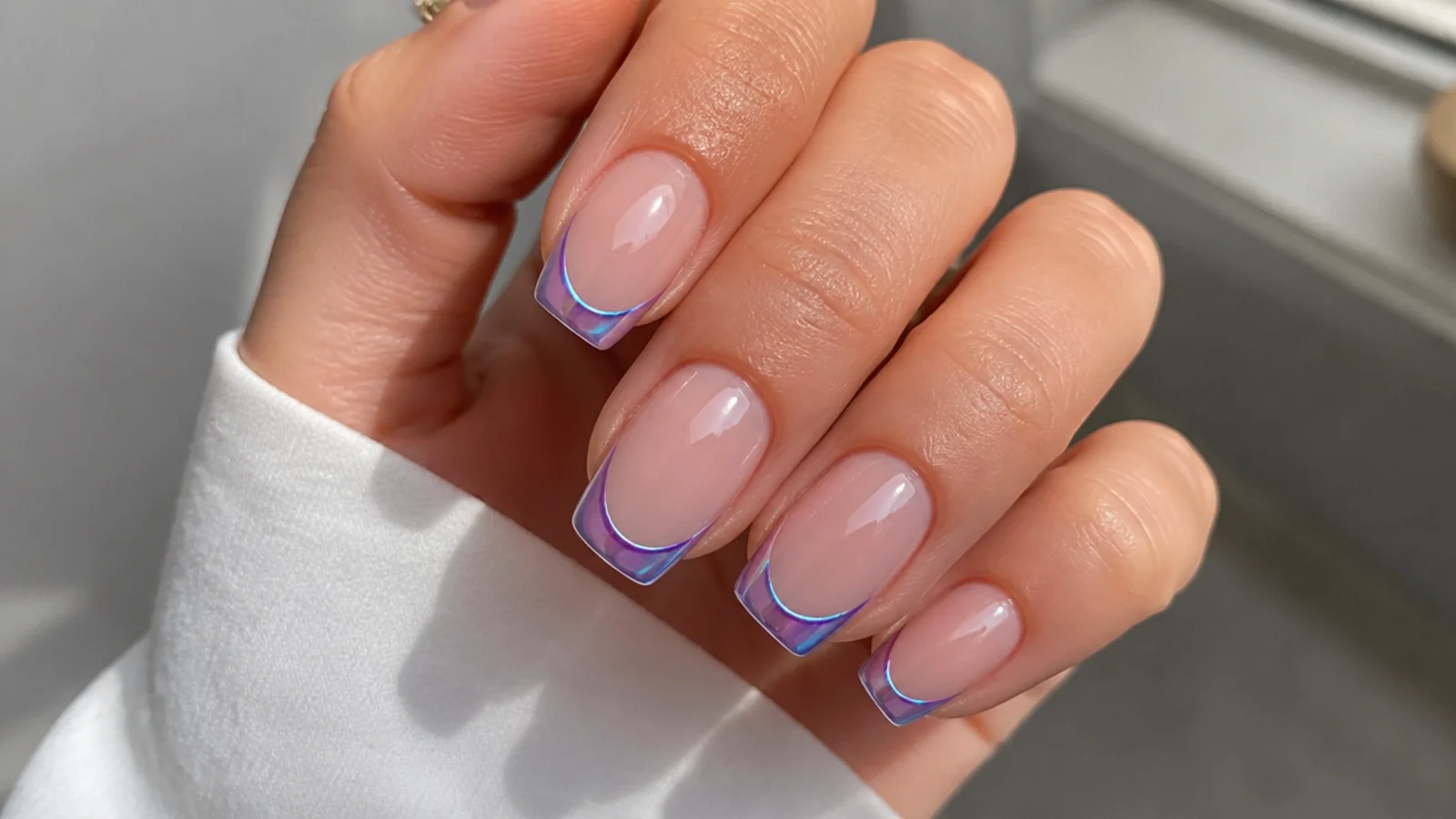 Nude nails with light blue and purple chrome French tips