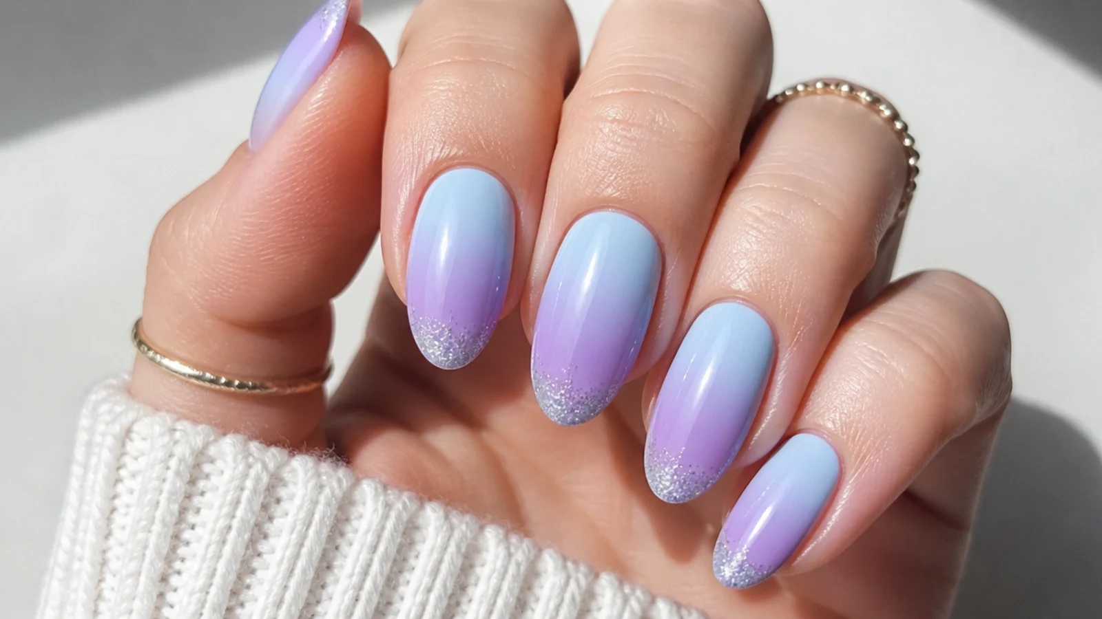 Light blue to purple ombre nails with a fine silver glitter tip