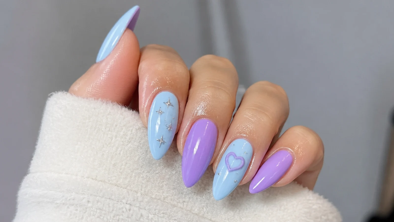 A sealed light blue and purple gel manicure with cuticle oil
