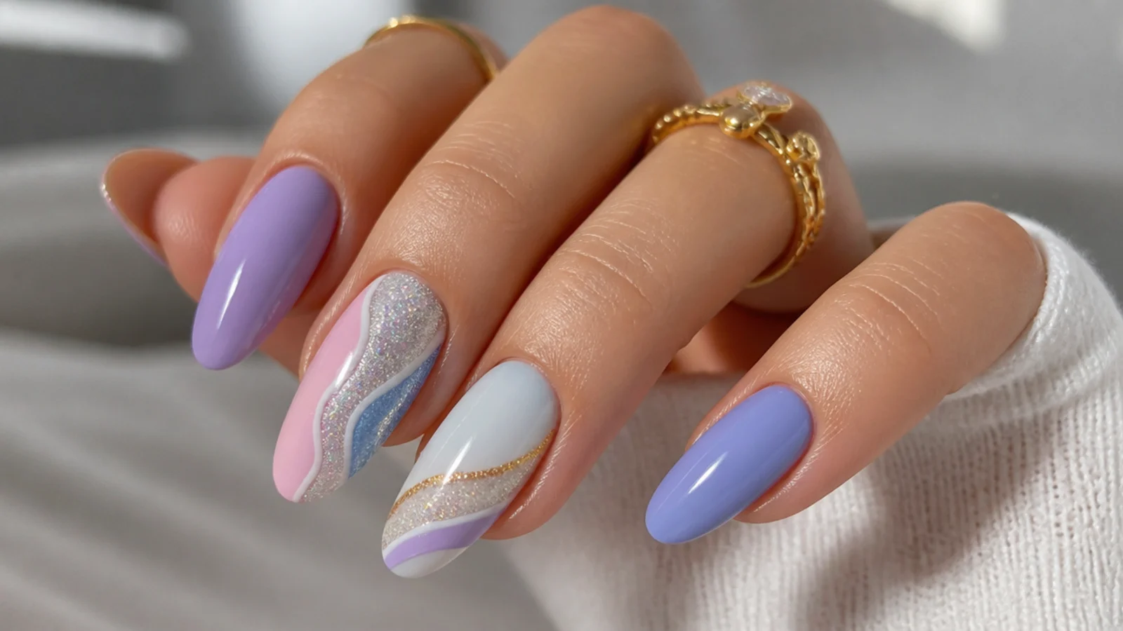 Light purple nails paired with blue, pink, white, silver and gold swatches