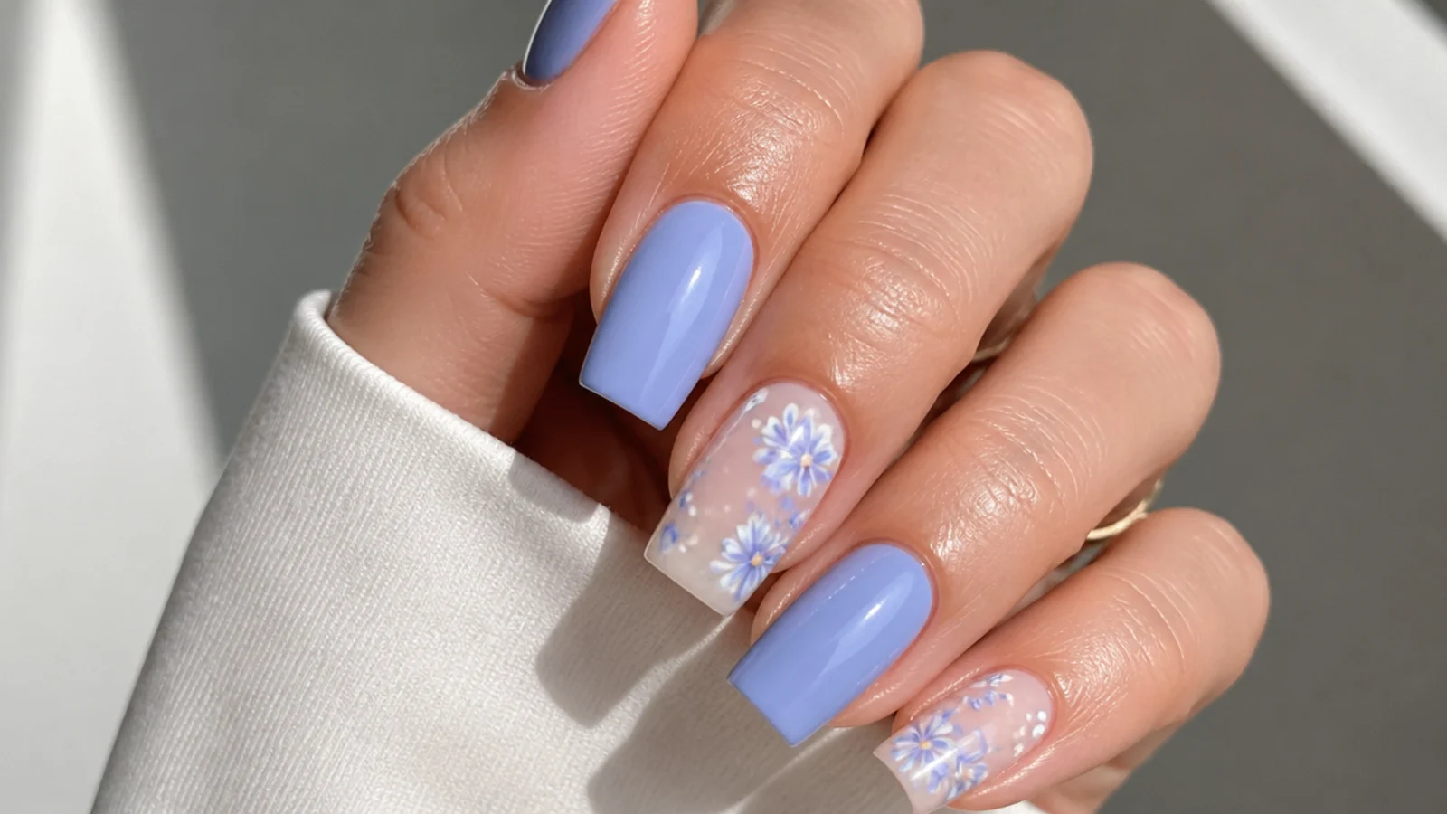 Cool blue-toned lilac acrylic nails on a square shape