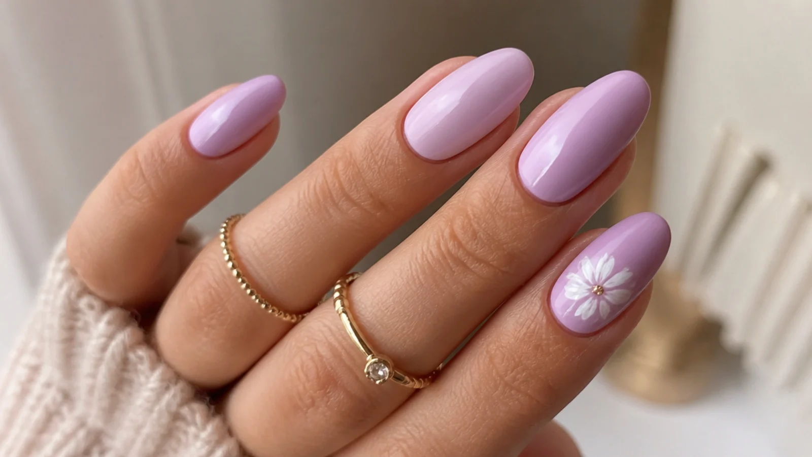 Light purple acrylic nails with a small hand-painted white flower accent
