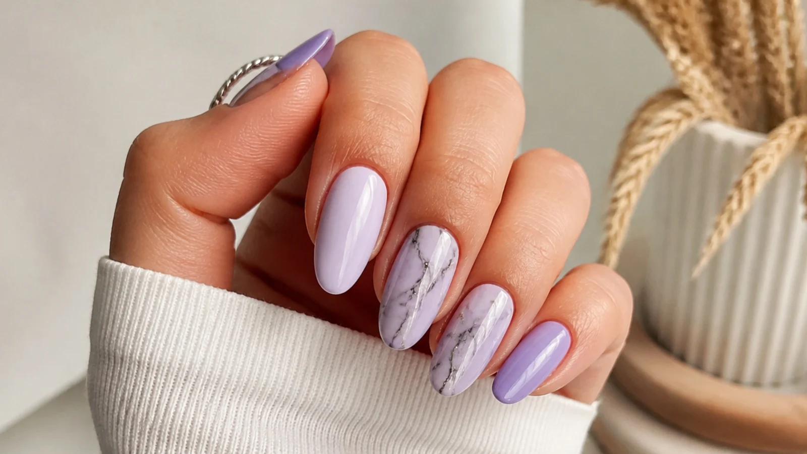 Light purple acrylic nails with black and gray marble accents