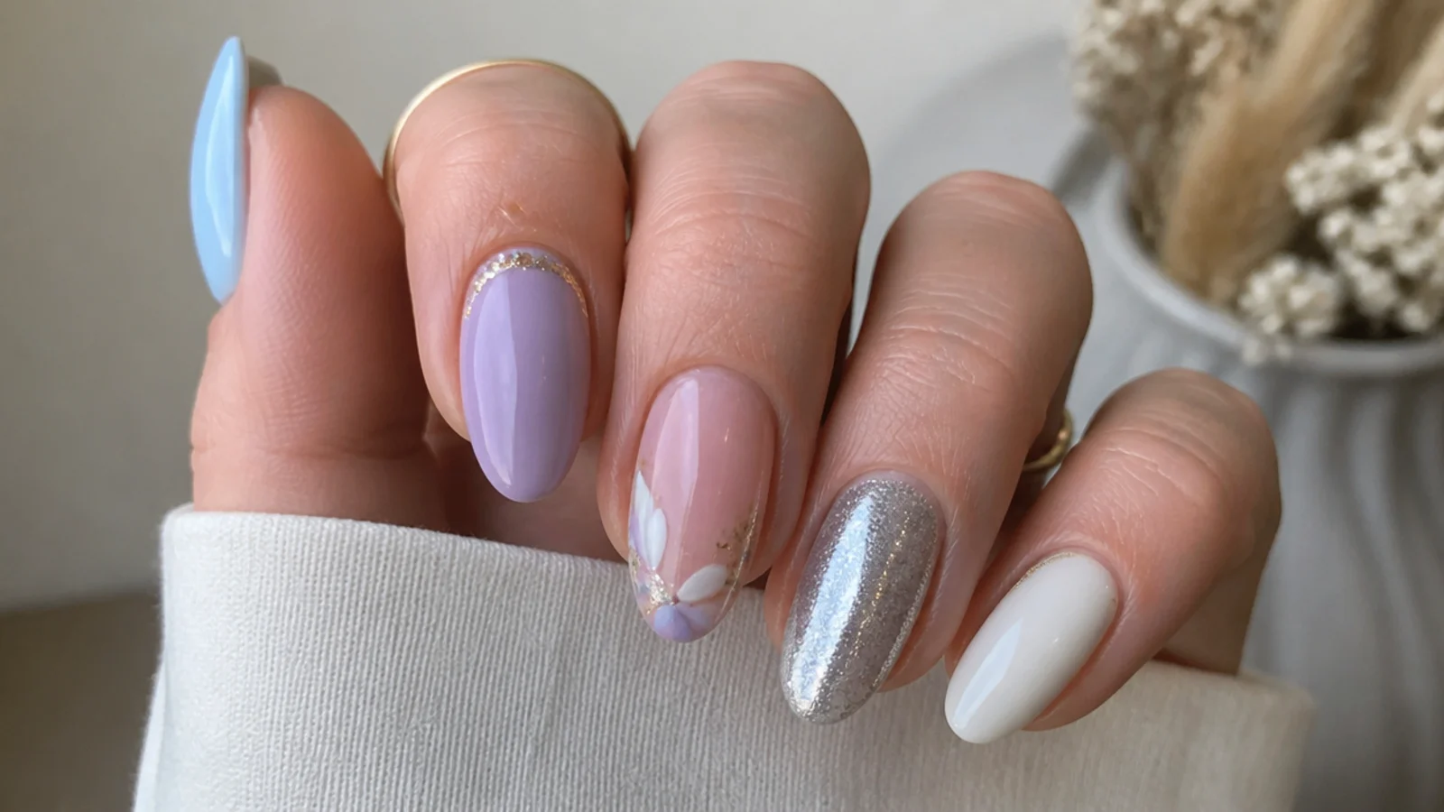 Light purple nails shown beside blue, pink, white, silver and gold accents