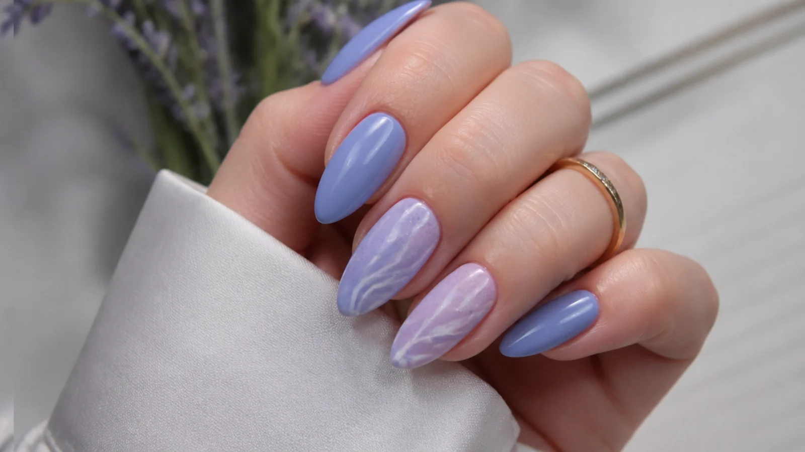 Cool blue-toned light purple almond nails on fair skin