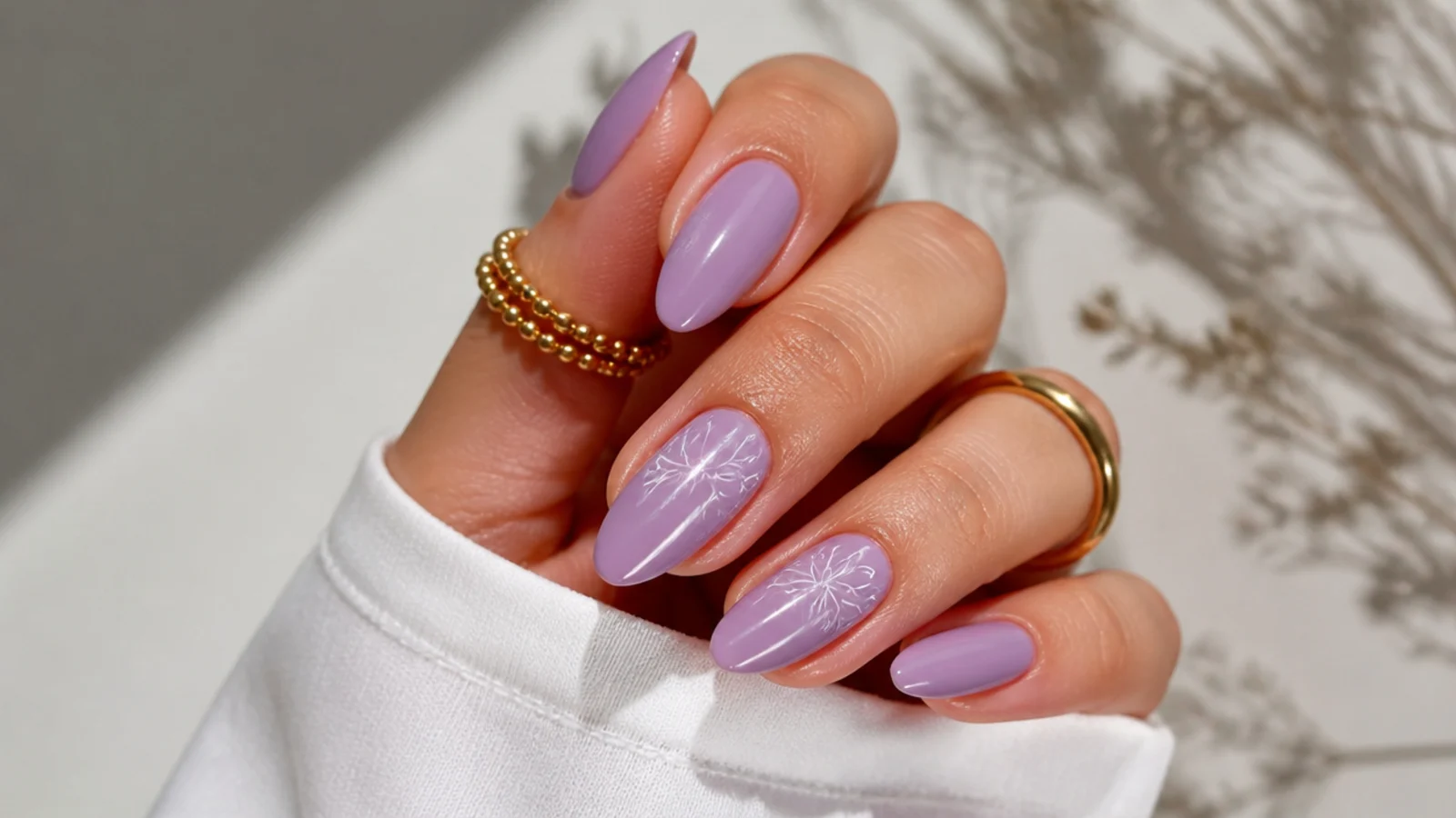 Warm pink-toned light purple almond nails on tan skin