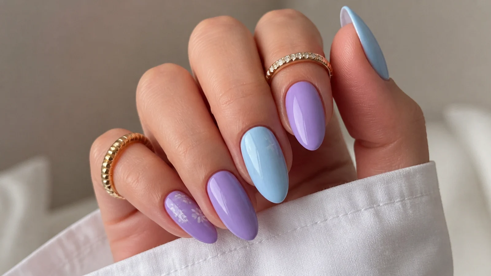Alternating light blue and light purple almond nails in a pastel duo