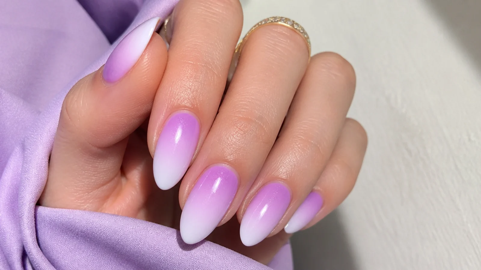 Light purple to white ombre almond nails with a soft gradient