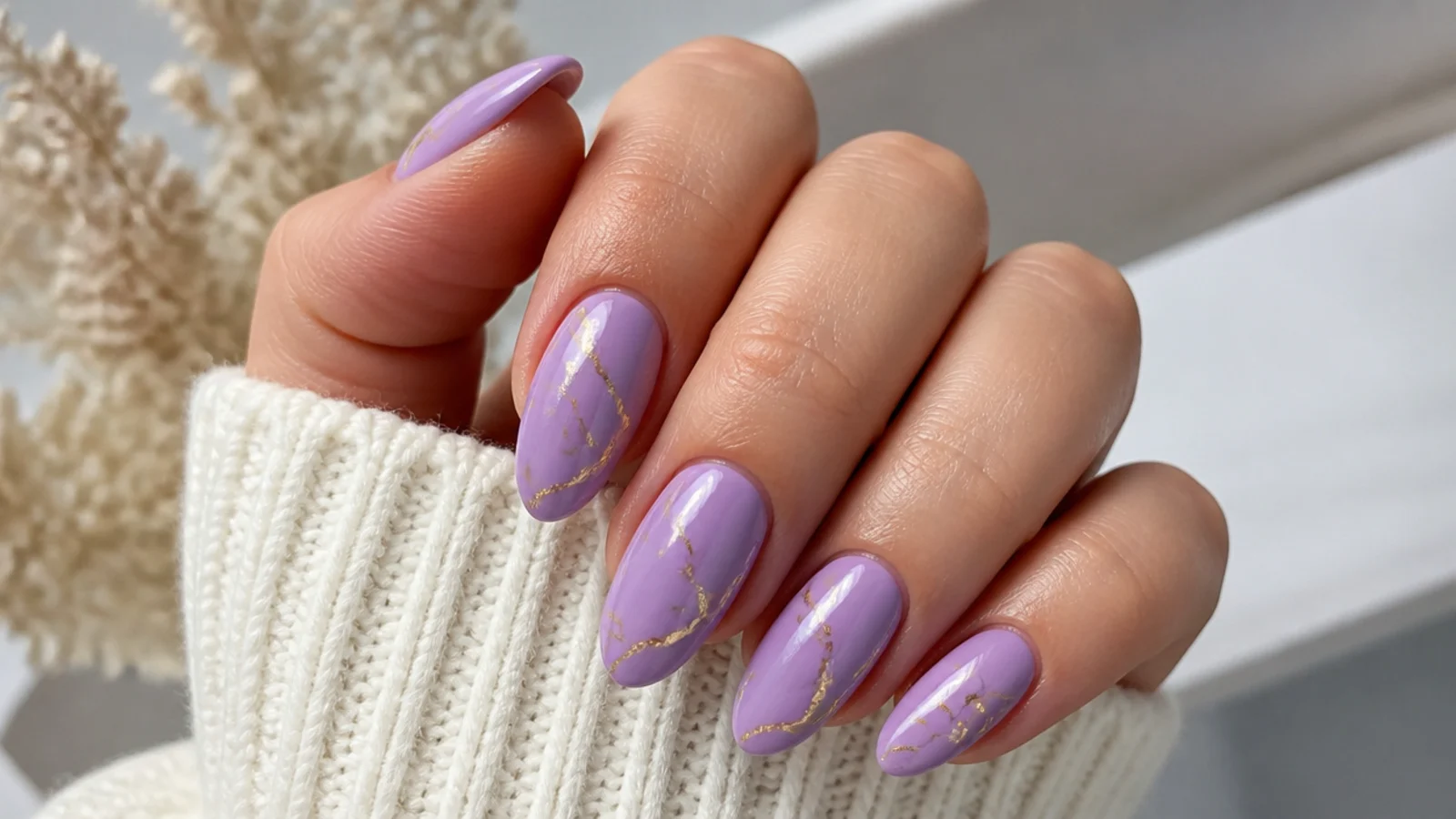 Light purple almond nails with thin gold foil accent lines
