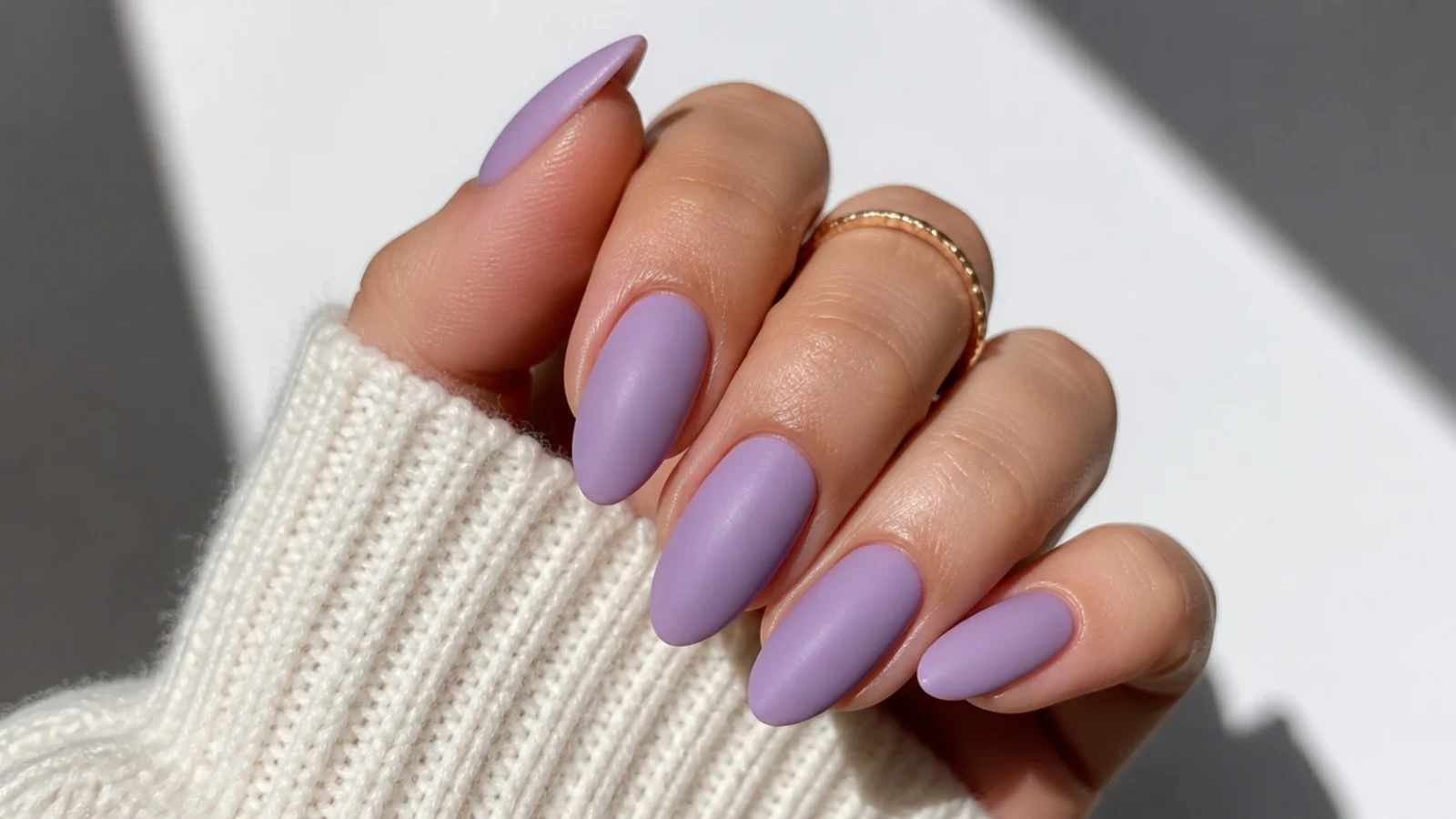 Soft matte light purple almond nails with a velvety finish
