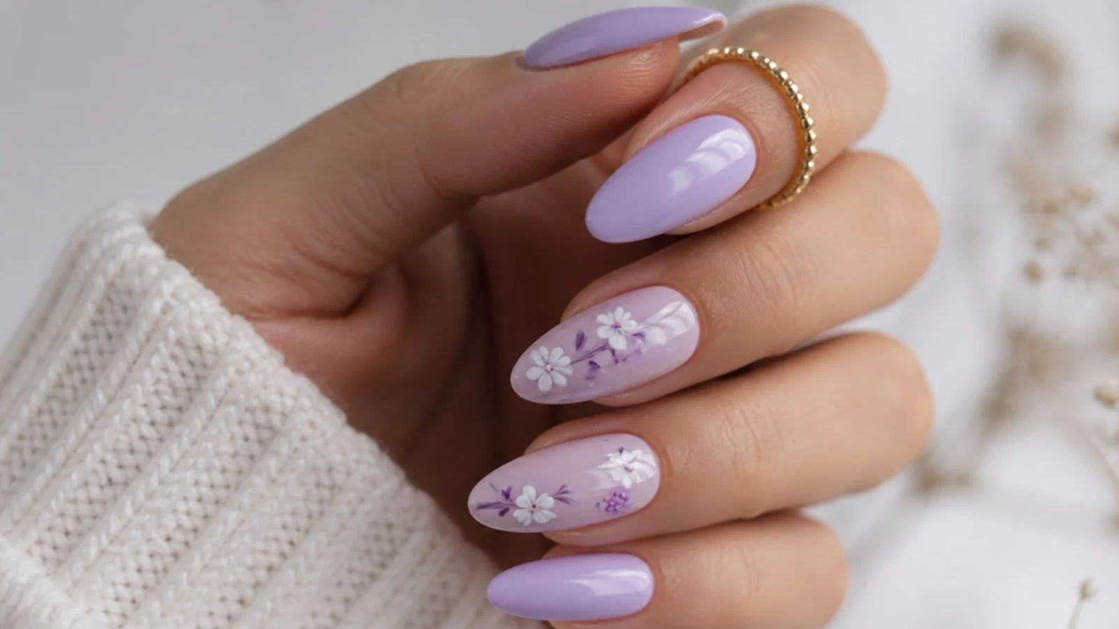 Light purple almond nails with small white and purple floral accents