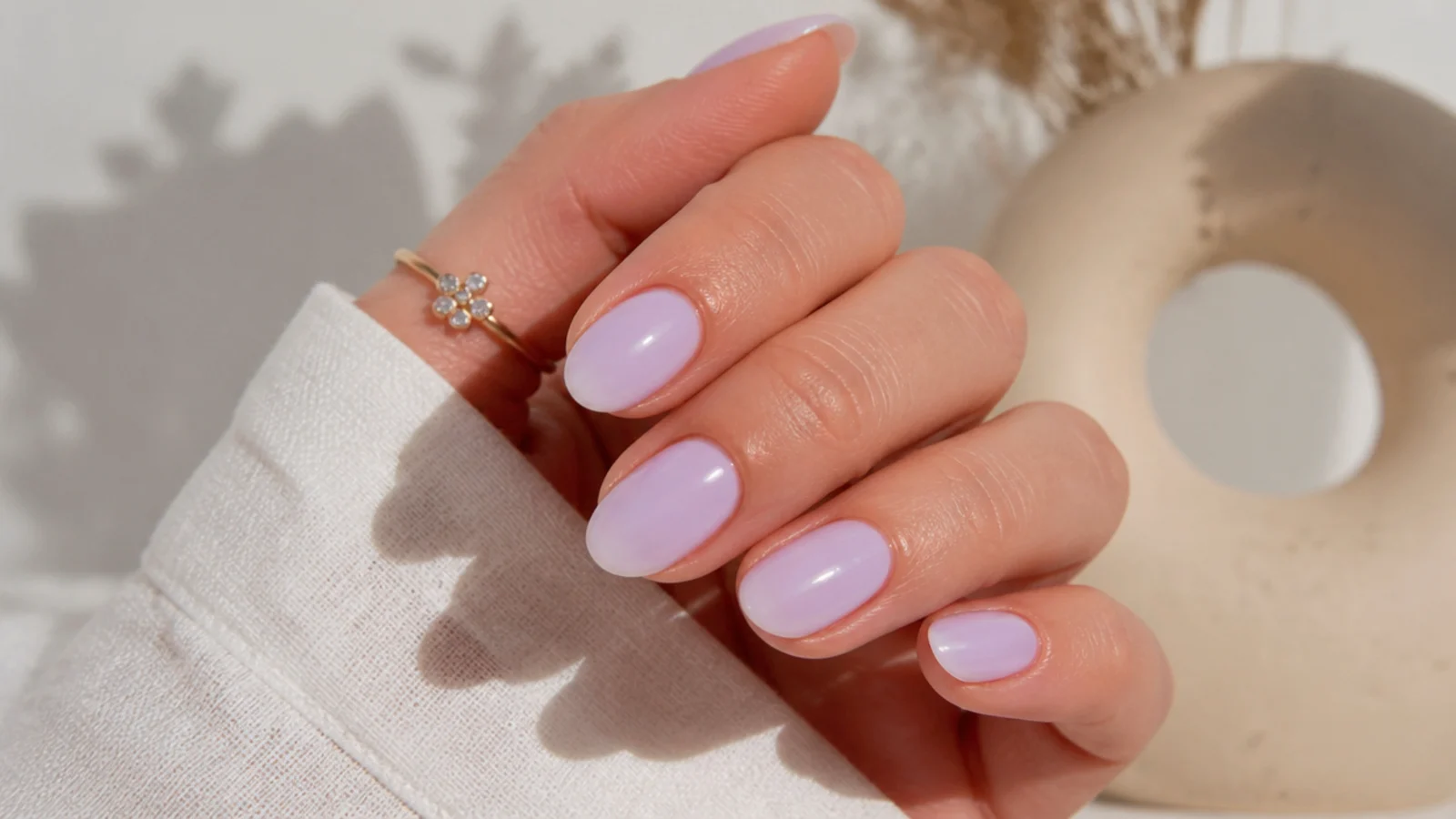 Short light purple almond nails with a clean milky finish