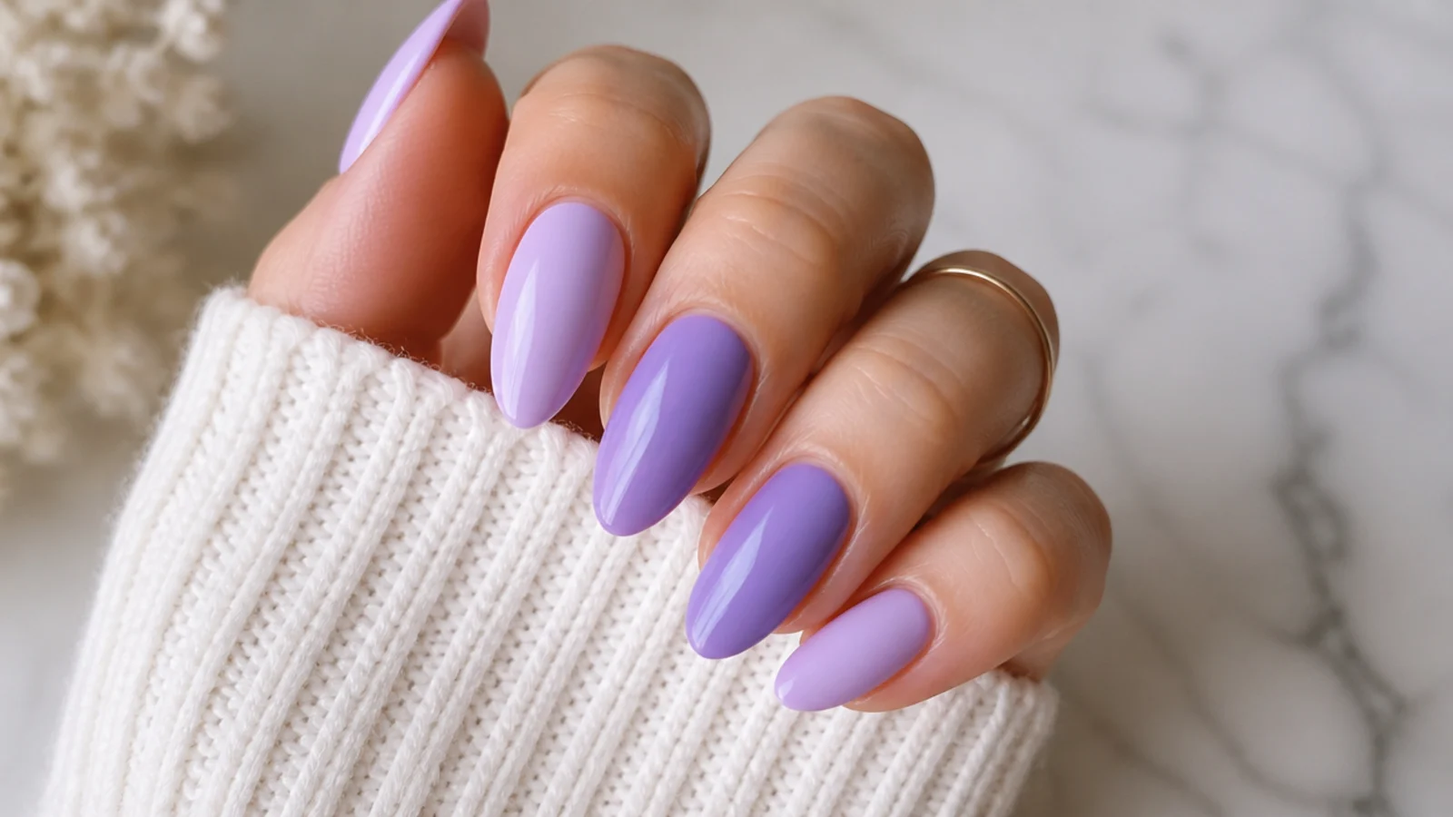 Almond nails alternating a lighter lilac and a deeper lavender purple