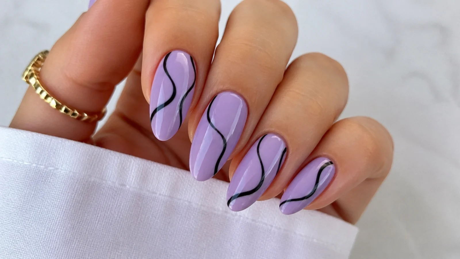 Light purple nails with wavy black swirl line art