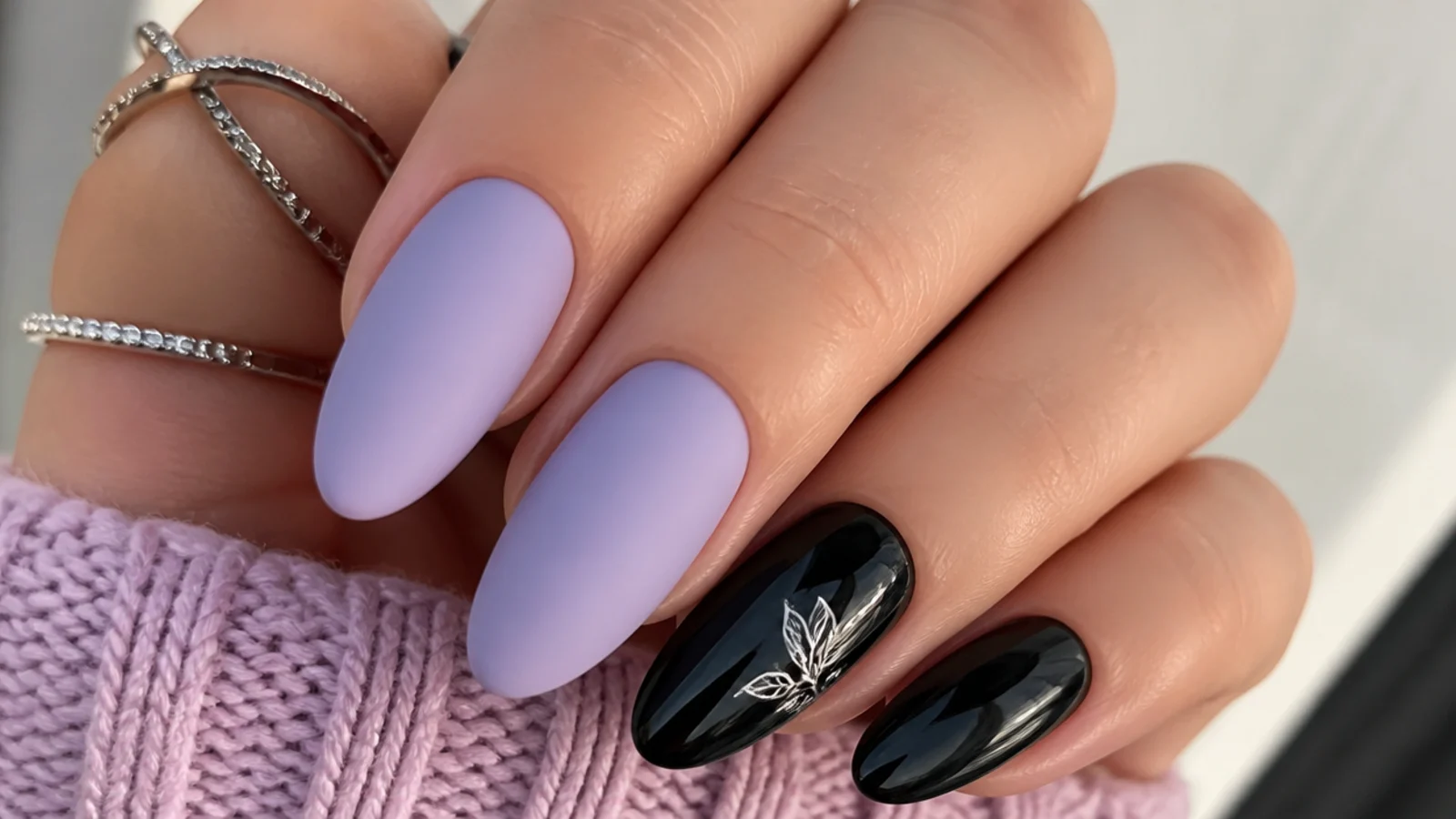 Matte pastel lilac nails alongside high-gloss black nails
