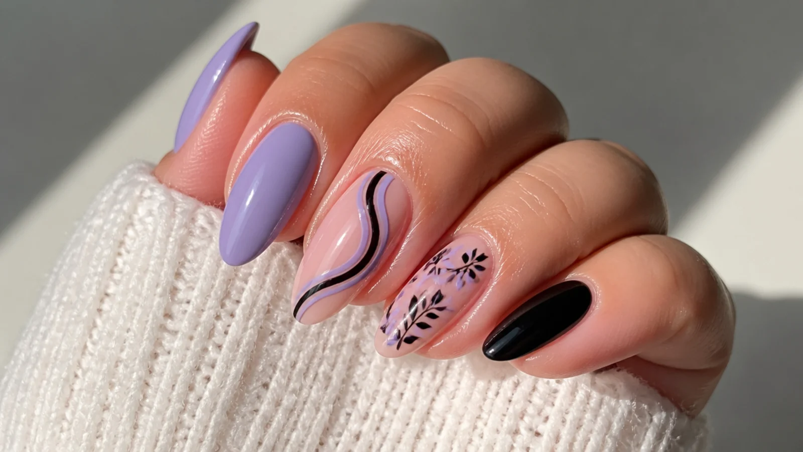 A well-sealed lilac and black gel manicure with cuticle oil for longevity
