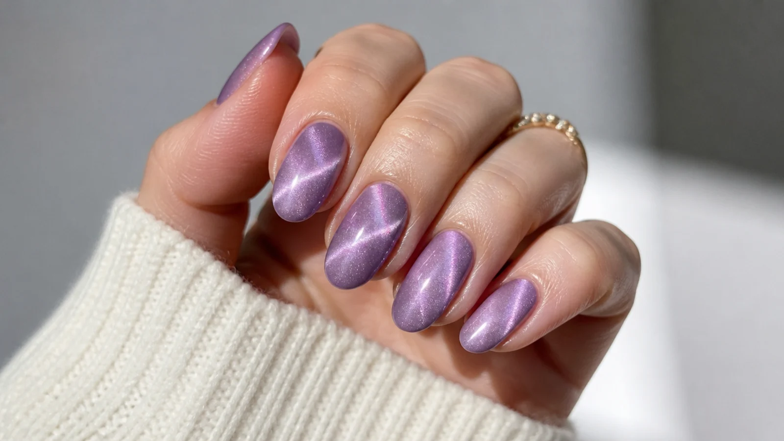 Lavender cat eye nails with a diagonal magnetic beam across each nail