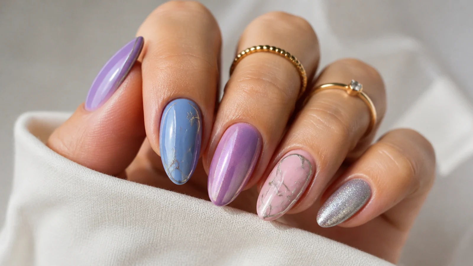 Light purple cat eye nails paired with light blue, soft pink and silver accents