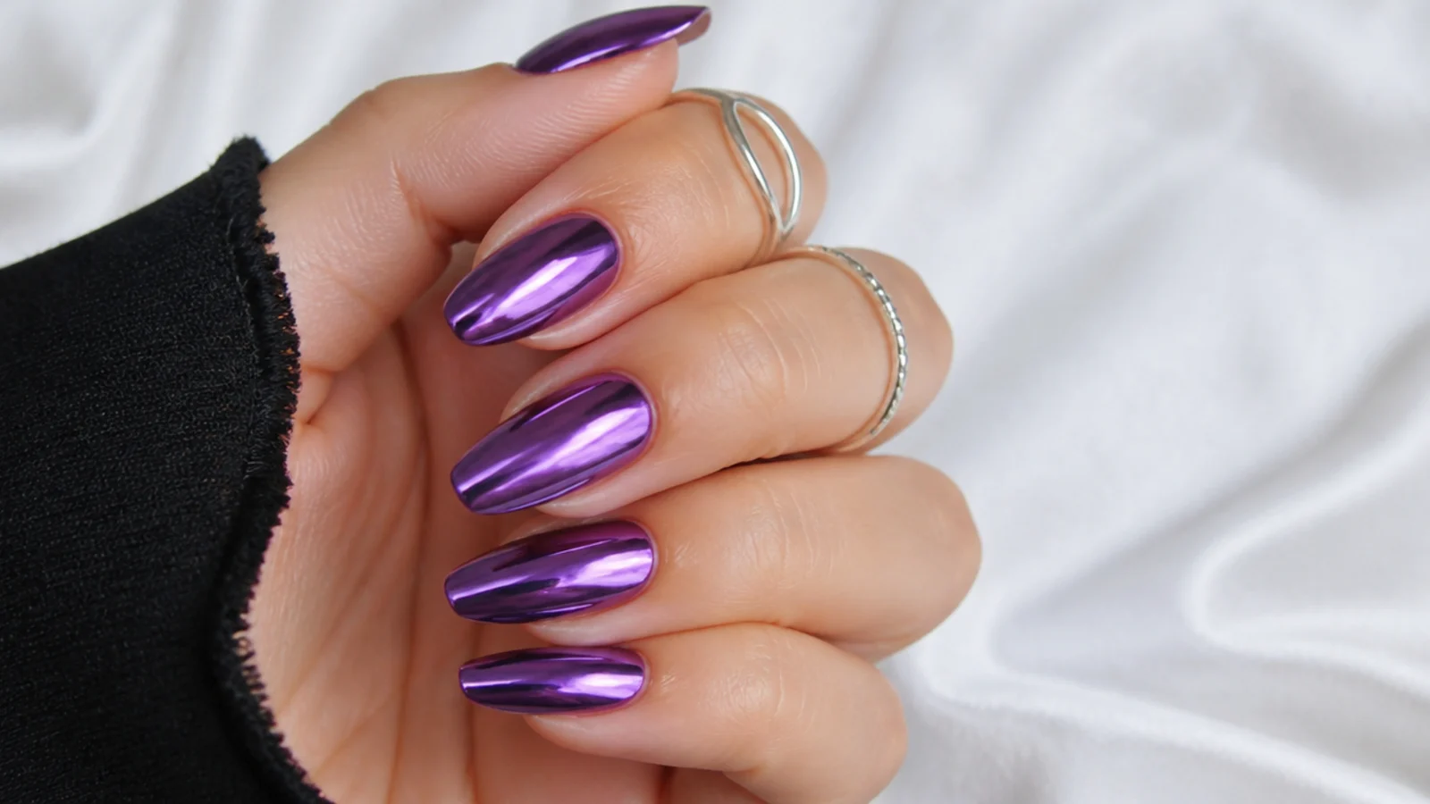 Deeper lilac chrome nails with a rich violet mirror finish for evening