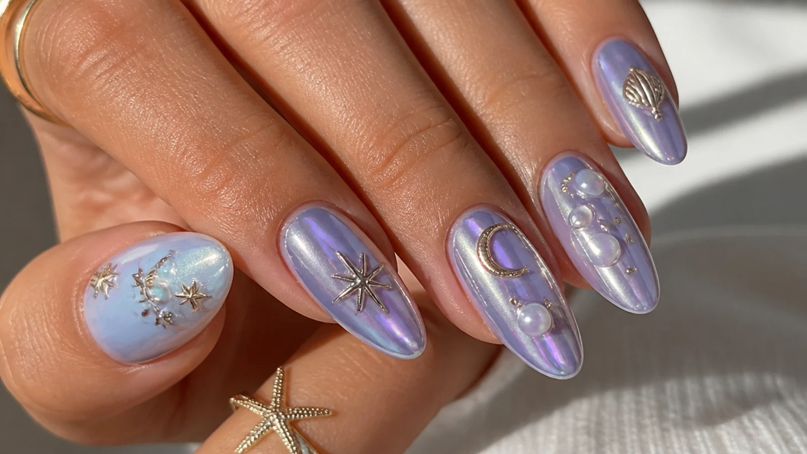 Light purple chrome nails shown beside blue, pink, white, silver and gold accents