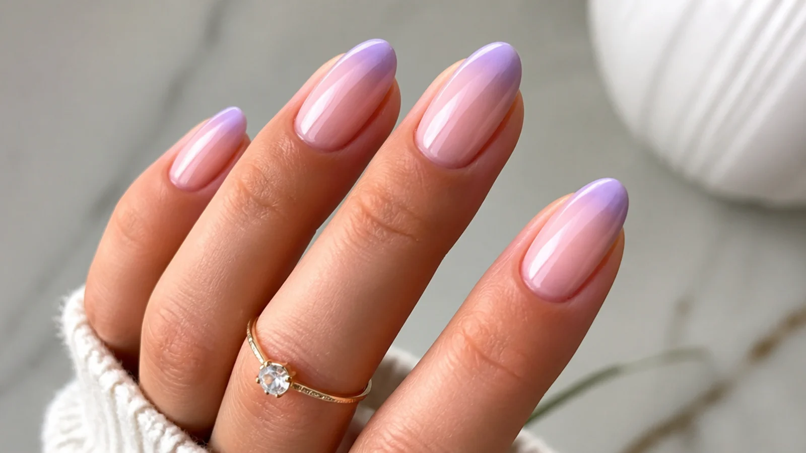 Soft lilac ombre french tips blending into a nude base