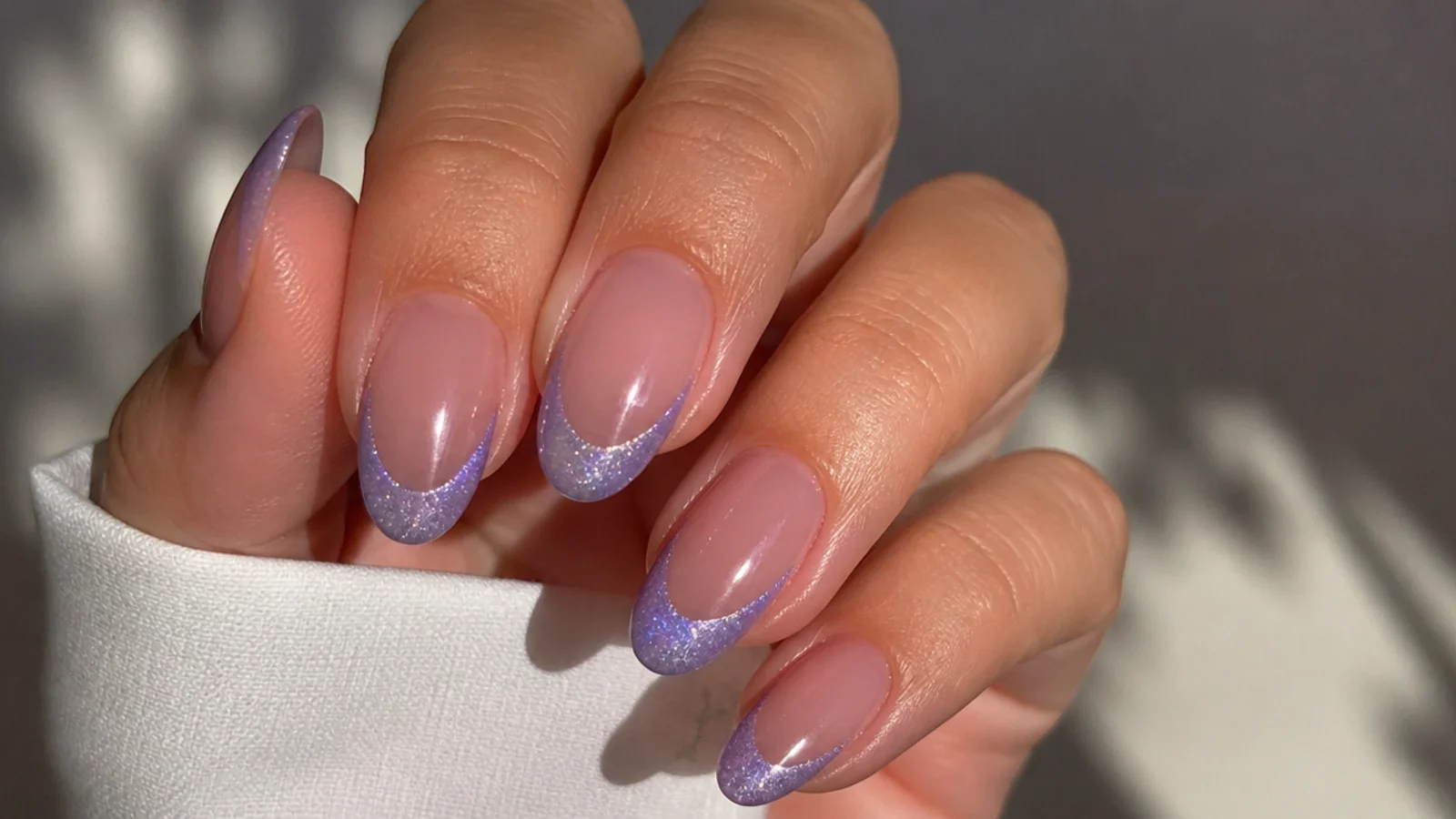 Lavender magnetic cat-eye french tips with a light strip on nude nails