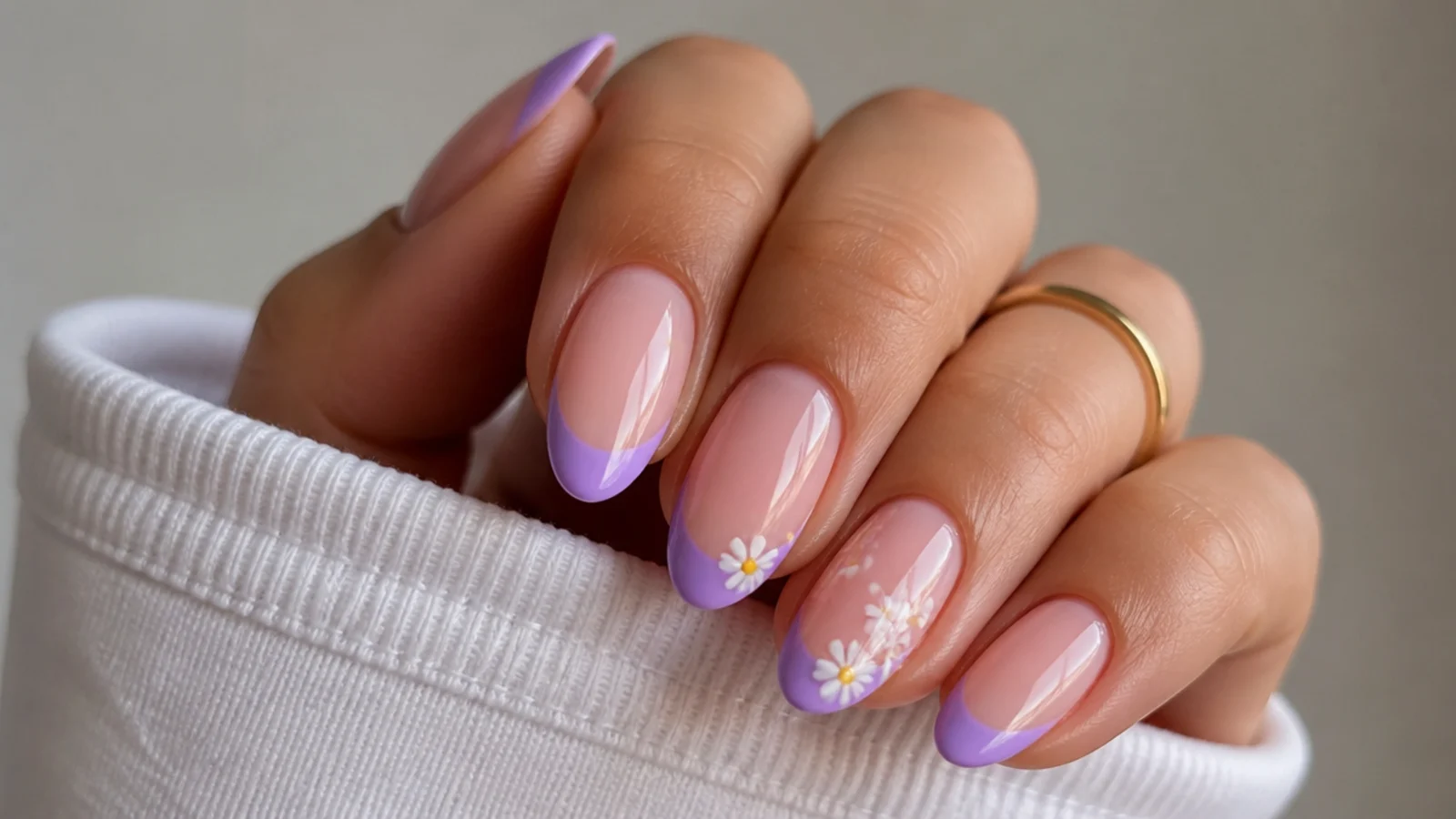 Light purple french tips with tiny white daisy accents on nude nails