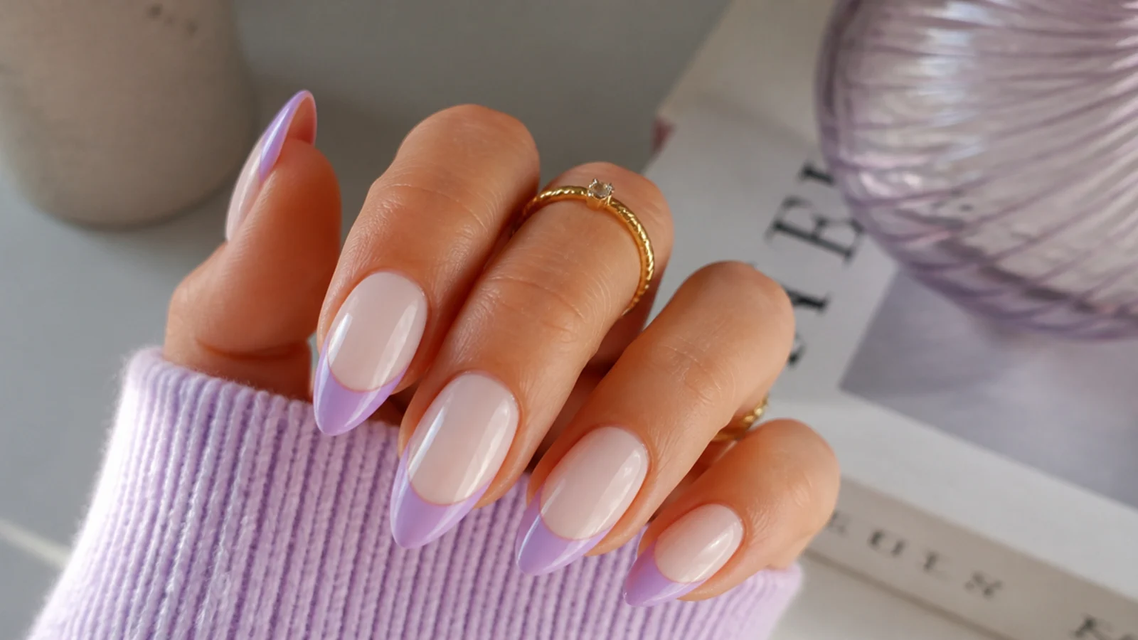 Soft lilac french tip nails on an almond shape over a milky base