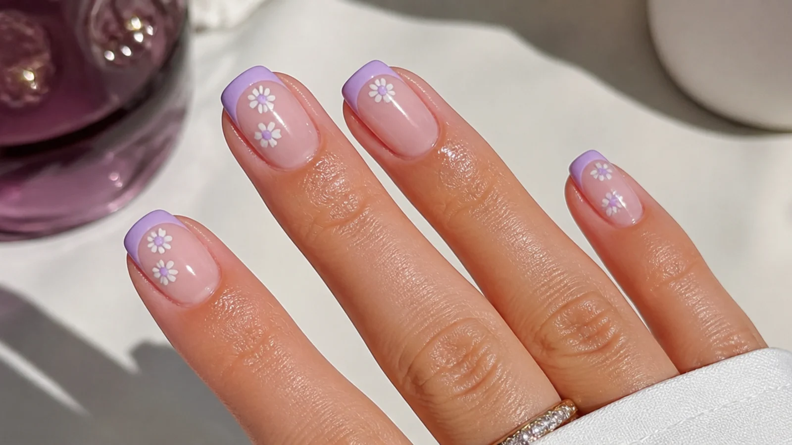 A sealed light purple french manicure with cuticle oil for longevity