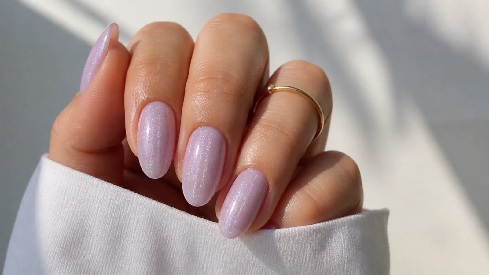 Milky light purple nails with a fine iridescent shimmer topper